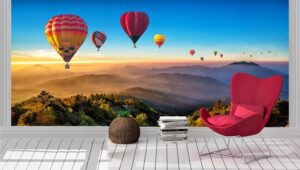 Colorful hot air balloons flying over mountain Wall Mural