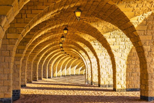 The arched stone colonnade with suspended lanterns Wall mural