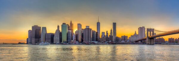 New York City downtown skyline and Brooklyn bridge at sunset